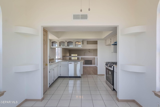 3148 Tierra Encino Dr, El Paso, TX 79938 - kitchen featuring appliances with stainless steel finishes, open shelves, light countertops, and under cabinet range hood