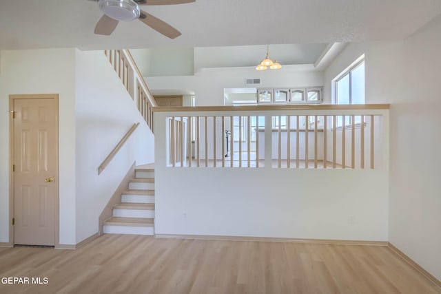 3148 Tierra Encino Dr, El Paso, TX 79938 - empty room featuring wood finished floors, ceiling fan, and stairs