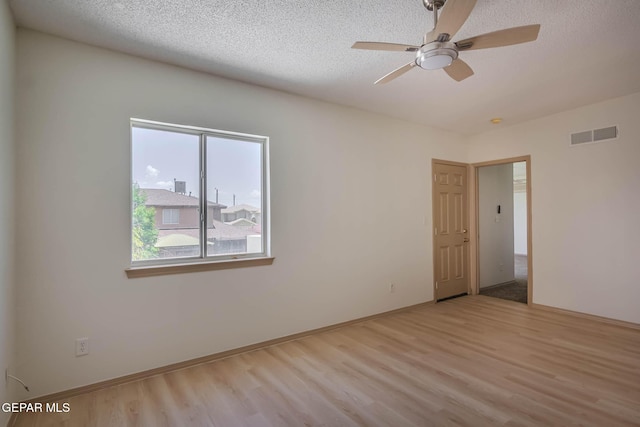 3148 Tierra Encino Dr, El Paso, TX 79938 - empty room with wood finished floors, a textured ceiling, and a ceiling fan