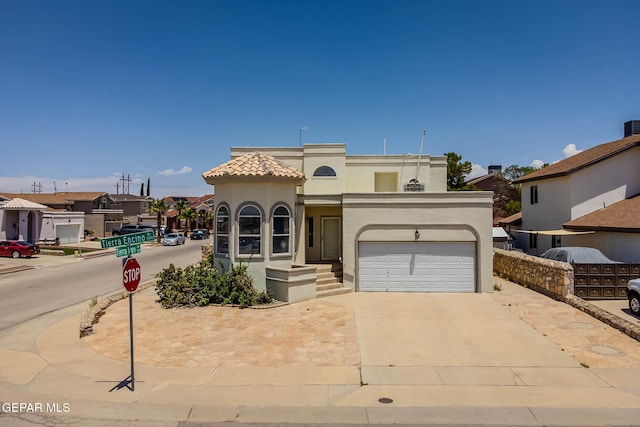 3148 Tierra Encino Dr, El Paso, TX 79938 - mediterranean / spanish-style house featuring stucco siding, driveway, a tiled roof, and an attached garage