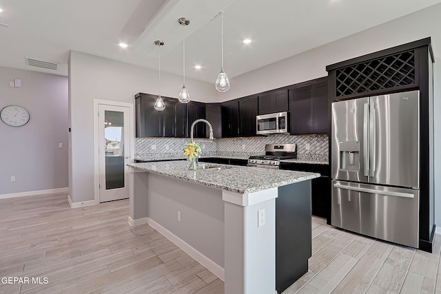 13860 Summer View Ave, El Paso, TX 79928 - kitchen with appliances with stainless steel finishes, decorative backsplash, light wood-style flooring, light stone counters, and recessed lighting