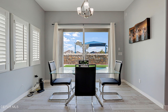 13860 Summer View Ave, El Paso, TX 79928 - dining room with healthy amount of natural light, wood finished floors, and a chandelier