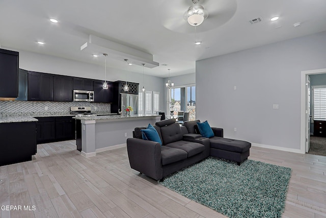 13860 Summer View Ave, El Paso, TX 79928 - living room featuring ceiling fan, light wood-style flooring, a chandelier, and recessed lighting