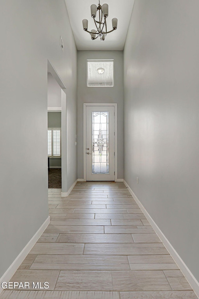 13860 Summer View Ave, El Paso, TX 79928 - entryway with a chandelier, healthy amount of natural light, wood finished floors, and a towering ceiling
