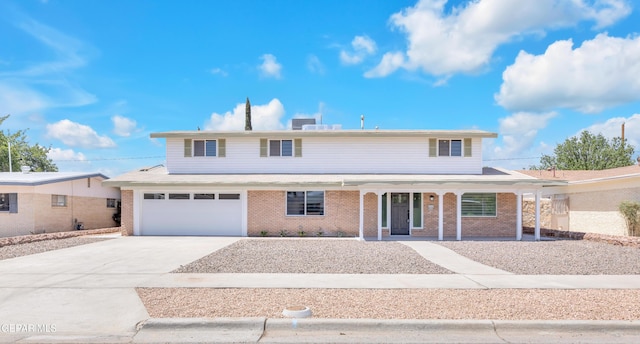 10229 Luella Ave, El Paso, TX 79925 - traditional-style home with a porch, driveway, brick siding, and a garage