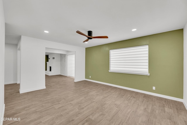 10229 Luella Ave, El Paso, TX 79925 - unfurnished living room featuring ceiling fan, a brick fireplace, recessed lighting, and wood finished floors