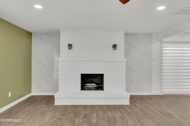 10229 Luella Ave, El Paso, TX 79925 - unfurnished living room with wood finished floors, a brick fireplace, and recessed lighting