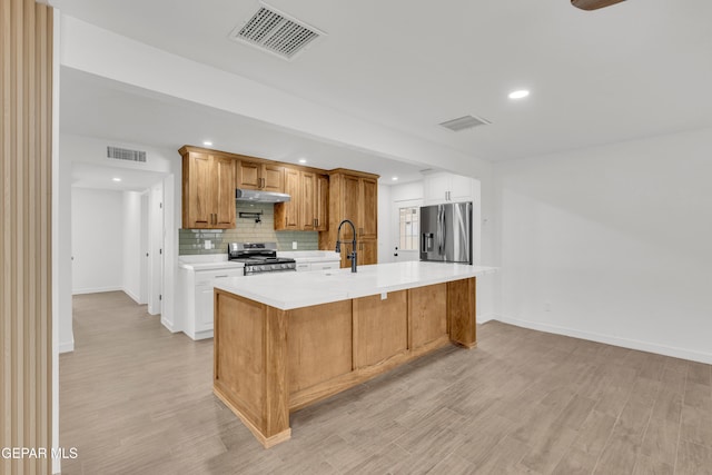 10229 Luella Ave, El Paso, TX 79925 - kitchen with appliances with stainless steel finishes, light countertops, recessed lighting, decorative backsplash, and light wood-style flooring