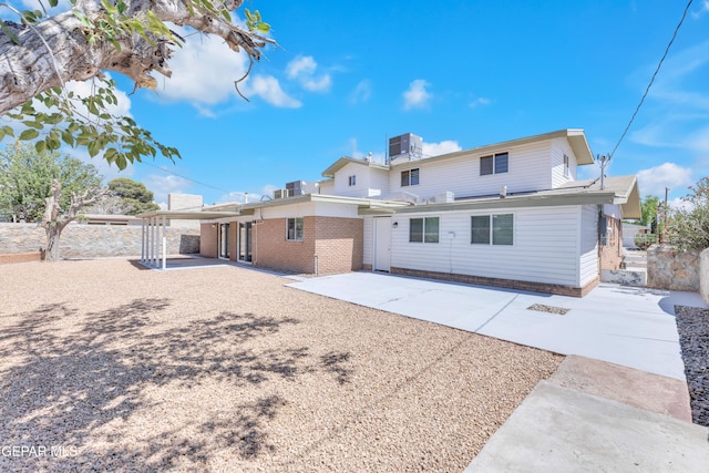 10229 Luella Ave, El Paso, TX 79925 - rear view of house with a patio area and brick siding
