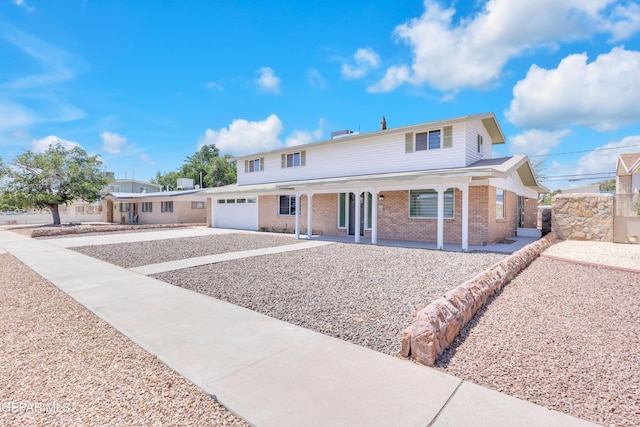 10229 Luella Ave, El Paso, TX 79925 - traditional home with brick siding, concrete driveway, a porch, and a garage