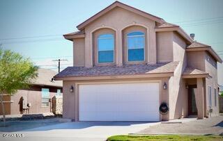 13643 Pecos River Rd, Clint, TX 79836 - view of front facade with an attached garage, stucco siding, and concrete driveway