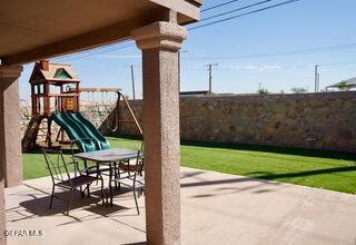 13643 Pecos River Rd, Clint, TX 79836 - fenced backyard with a patio area and a playground