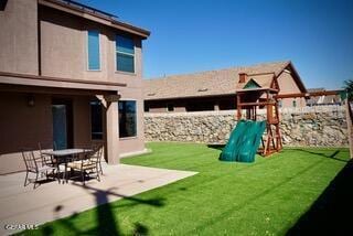 13643 Pecos River Rd, Clint, TX 79836 - back of house featuring a playground, a patio, a yard, and stucco siding