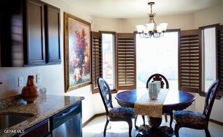 13643 Pecos River Rd, Clint, TX 79836 - dining area featuring a chandelier and baseboards