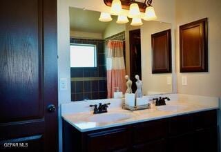 13643 Pecos River Rd, Clint, TX 79836 - bathroom with double vanity, a chandelier, and curtained shower