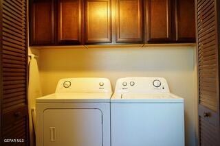 13643 Pecos River Rd, Clint, TX 79836 - washroom featuring washer and dryer and cabinet space