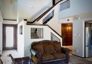 13643 Pecos River Rd, Clint, TX 79836 - living area featuring stairs and a towering ceiling