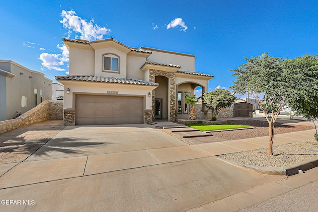 12511 Furlong Cir, El Paso, TX 79928 - mediterranean / spanish-style home featuring stucco siding, stone siding, a garage, and driveway