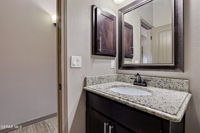 12511 Furlong Cir, El Paso, TX 79928 - bathroom with vanity, wood finished floors, and a textured wall