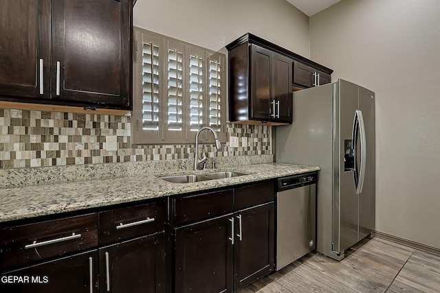 12511 Furlong Cir, El Paso, TX 79928 - kitchen featuring stainless steel appliances, decorative backsplash, dark brown cabinets, and light stone counters