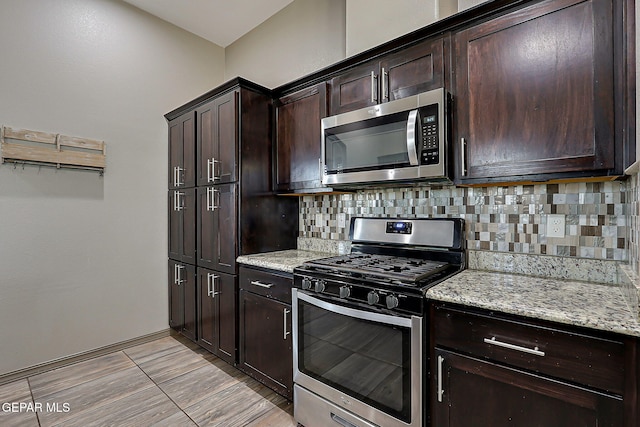 12511 Furlong Cir, El Paso, TX 79928 - kitchen with appliances with stainless steel finishes, backsplash, dark brown cabinetry, and light stone counters