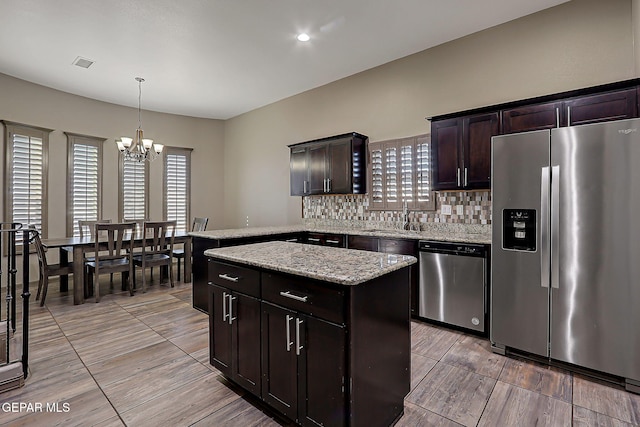 12511 Furlong Cir, El Paso, TX 79928 - kitchen featuring stainless steel appliances, a chandelier, tasteful backsplash, a kitchen island, and pendant lighting