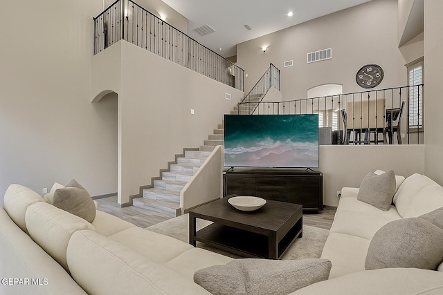 12511 Furlong Cir, El Paso, TX 79928 - living area featuring a towering ceiling, wood finished floors, arched walkways, stairs, and recessed lighting