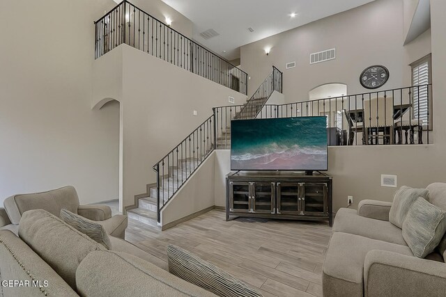 12511 Furlong Cir, El Paso, TX 79928 - living room with a towering ceiling, stairway, and wood finished floors