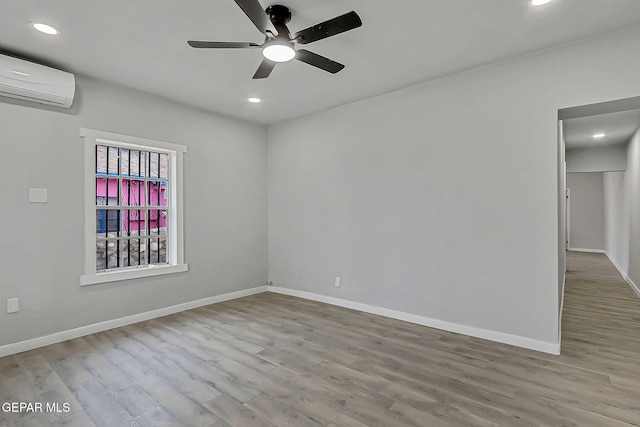209 Hardesty Pl, El Paso, TX 79905 - unfurnished room featuring an AC wall unit, wood finished floors, a ceiling fan, and recessed lighting