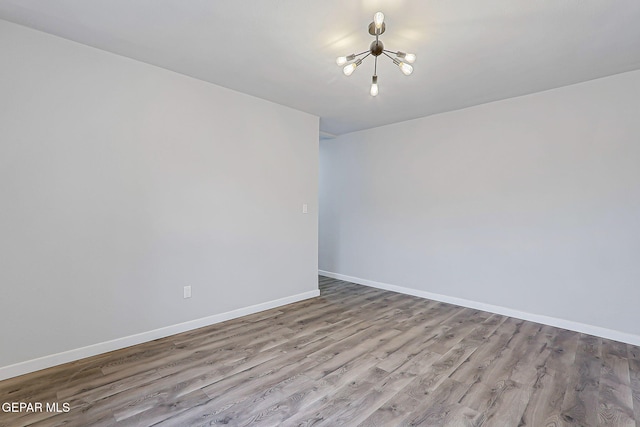 209 Hardesty Pl, El Paso, TX 79905 - empty room with a chandelier and wood finished floors
