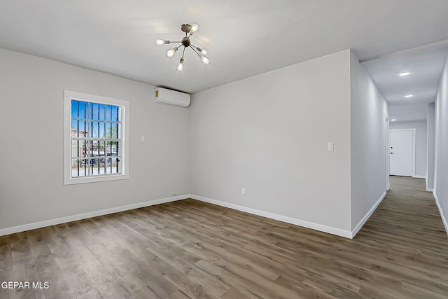 209 Hardesty Pl, El Paso, TX 79905 - empty room with a wall mounted air conditioner, a chandelier, and wood finished floors