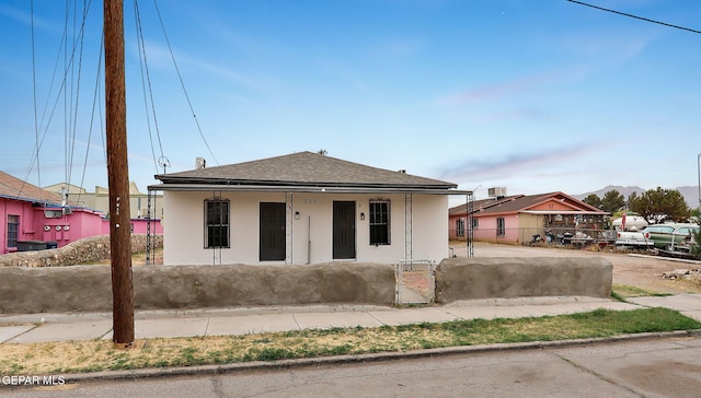 209 Hardesty Pl, El Paso, TX 79905 - view of front of house with stucco siding, a gate, covered porch, and roof with shingles