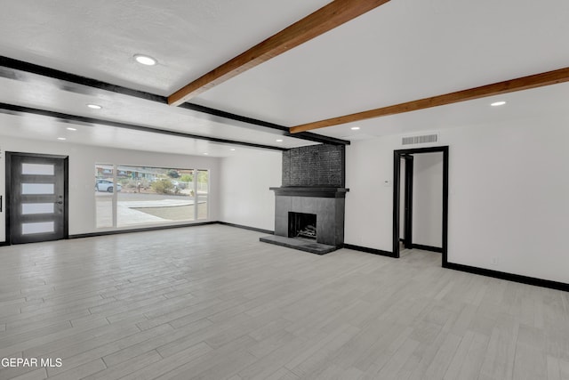 3116 Titanic Ave, El Paso, TX 79904 - unfurnished living room with beamed ceiling, a large fireplace, light wood-type flooring, and recessed lighting
