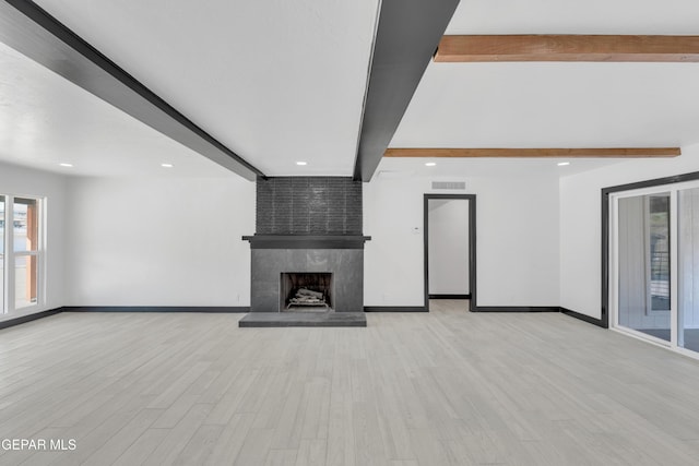 3116 Titanic Ave, El Paso, TX 79904 - unfurnished living room with beamed ceiling, recessed lighting, light wood-style floors, healthy amount of natural light, and a large fireplace
