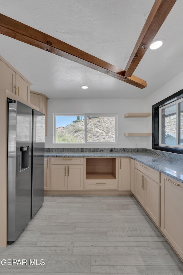 3116 Titanic Ave, El Paso, TX 79904 - kitchen with stainless steel fridge, open shelves, beamed ceiling, light wood-style floors, and cream cabinets