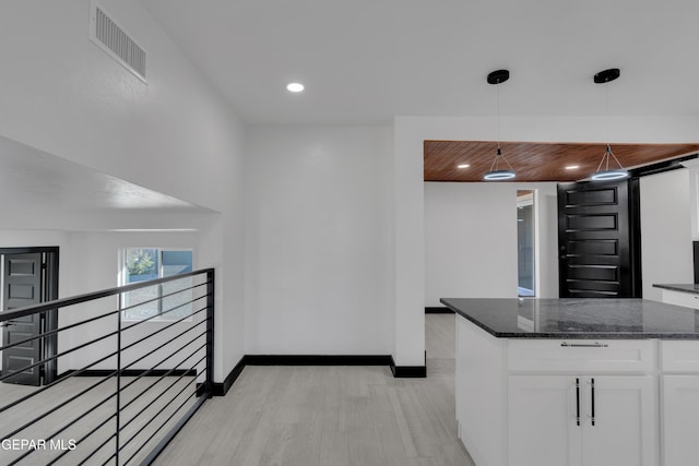 3116 Titanic Ave, El Paso, TX 79904 - kitchen with white cabinets, dark stone counters, decorative light fixtures, and recessed lighting