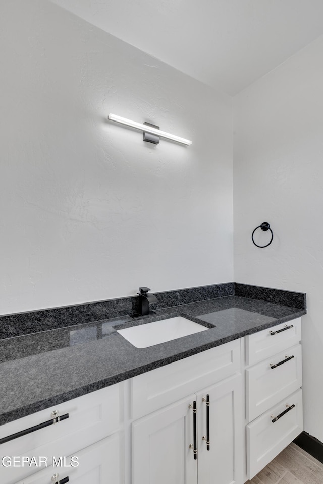 3116 Titanic Ave, El Paso, TX 79904 - bathroom featuring vanity and wood finished floors