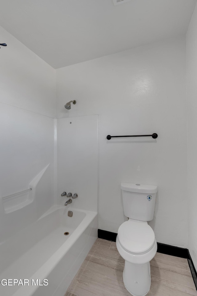 3116 Titanic Ave, El Paso, TX 79904 - bathroom featuring wood finished floors and washtub / shower combination
