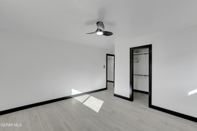 3116 Titanic Ave, El Paso, TX 79904 - unfurnished bedroom featuring light wood finished floors, a spacious closet, a ceiling fan, and a closet