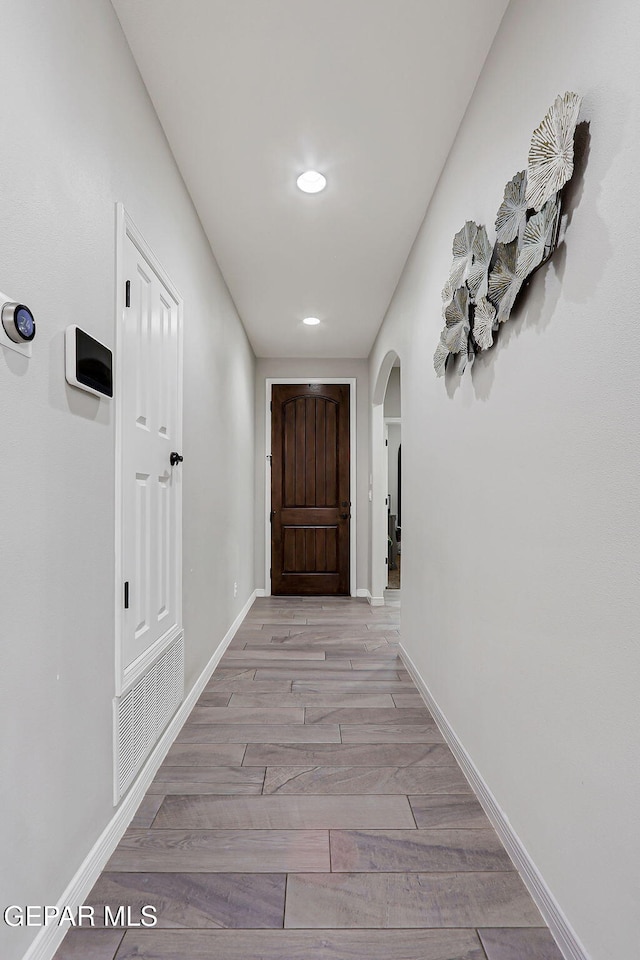 13120 Wesleyan, El Paso, TX 79928 - hall featuring arched walkways, recessed lighting, and light wood-style flooring