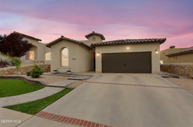 13120 Wesleyan, El Paso, TX 79928 - mediterranean / spanish home featuring driveway, stucco siding, an attached garage, and a tile roof