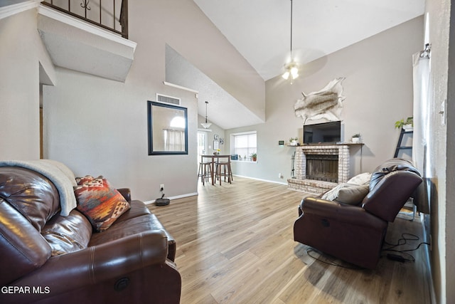 5823 Chippendale Ave, El Paso, TX 79934 - living room with wood finished floors, vaulted ceiling, ceiling fan, and a fireplace