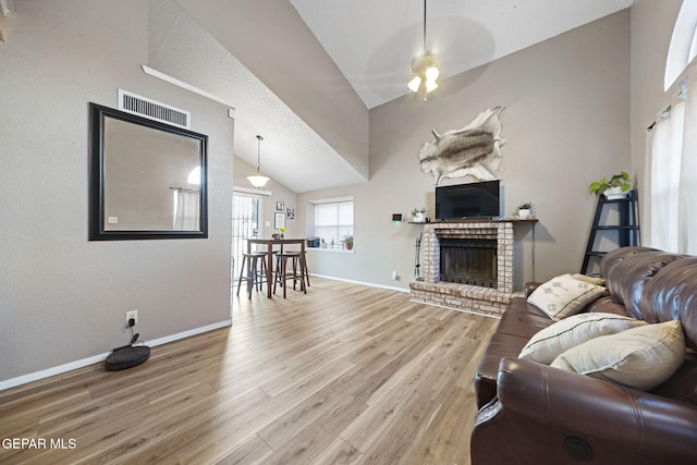 5823 Chippendale Ave, El Paso, TX 79934 - living room with vaulted ceiling, ceiling fan, wood finished floors, and a fireplace