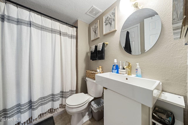 5823 Chippendale Ave, El Paso, TX 79934 - bathroom with a textured wall, tile patterned floors, a textured ceiling, vanity, and a shower with shower curtain