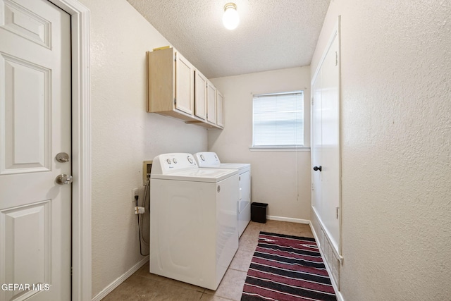 5823 Chippendale Ave, El Paso, TX 79934 - washroom featuring cabinet space, light tile patterned floors, a textured ceiling, washer and clothes dryer, and a textured wall