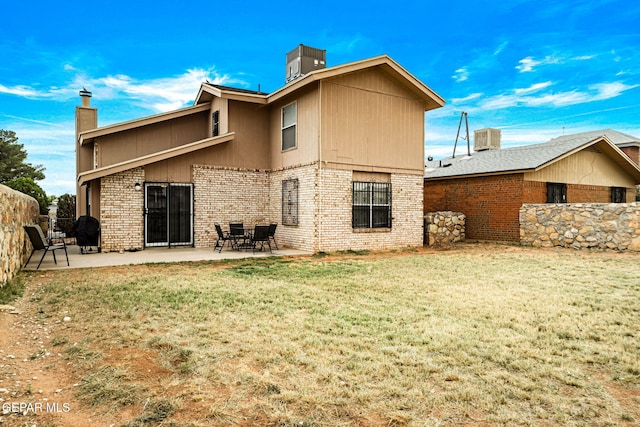 5823 Chippendale Ave, El Paso, TX 79934 - rear view of house with a chimney, a patio, and brick siding