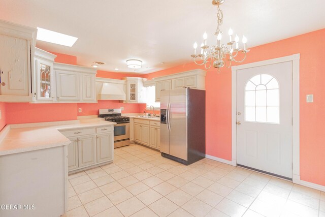 10324 Shoshone St, El Paso, TX 79924 - kitchen featuring appliances with stainless steel finishes, custom exhaust hood, light countertops, and healthy amount of natural light
