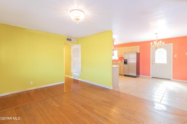 10324 Shoshone St, El Paso, TX 79924 - unfurnished living room with a chandelier and light wood finished floors