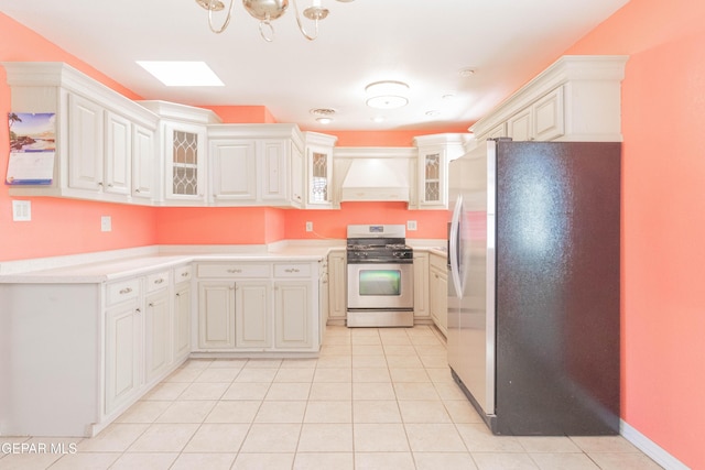 10324 Shoshone St, El Paso, TX 79924 - kitchen with appliances with stainless steel finishes, custom range hood, light countertops, and light tile patterned floors