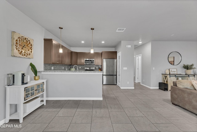 203 Bretby Pl, El Paso, TX 79928 - kitchen featuring stainless steel appliances, open floor plan, tasteful backsplash, recessed lighting, and a peninsula